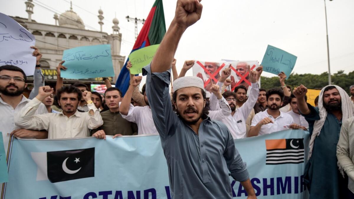 Students of Islami Jamiat-e-Talaba (IJT), a wing of religious political party Pakistan Jamaat-e-Islami (JI), burn a photograph of Indian Prime Minister Narendra Modi during a protest in Peshawar  ABDUL MAJEED / AFP