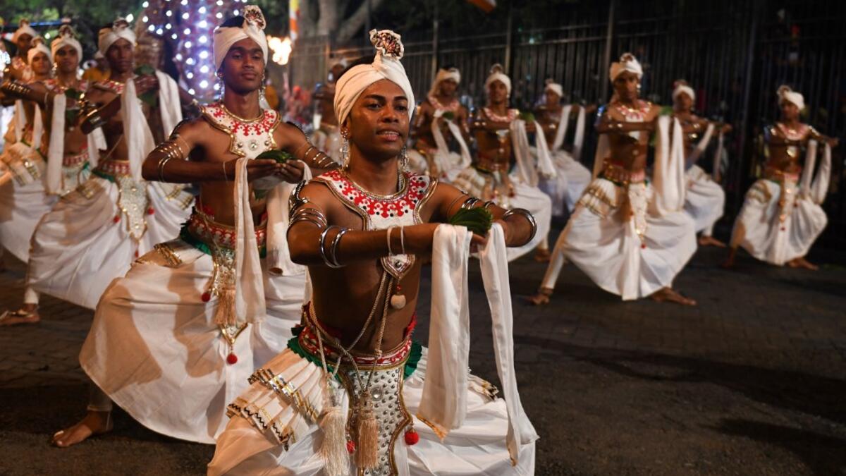 In this photograph taken on August 14, 2019 dancers perform during the "Esala Perahera" festival near the Buddhist temple of the Tooth in the ancient hill capital of Kandy, some 116 kilometres from Colombo. Lakruwan WANNIARACHCHI / AFP