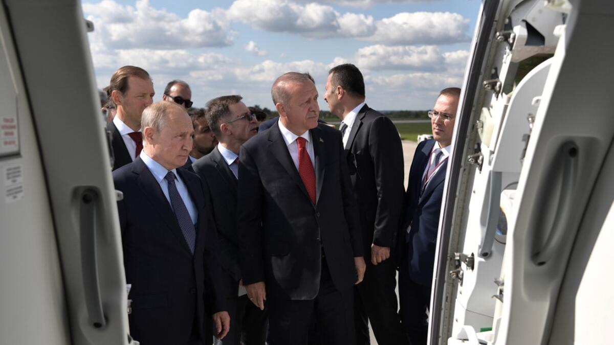 Russian President Vladimir Putin (L) shakes hands with his Turkish counterpart Recep Tayyip Erdogan visit the MAKS-2019 International Aviation and Space Salon opening day in Zhukovsky outside Moscow on August 27, 2019.  Alexey NIKOLSKY / SPUTNIK / AFP