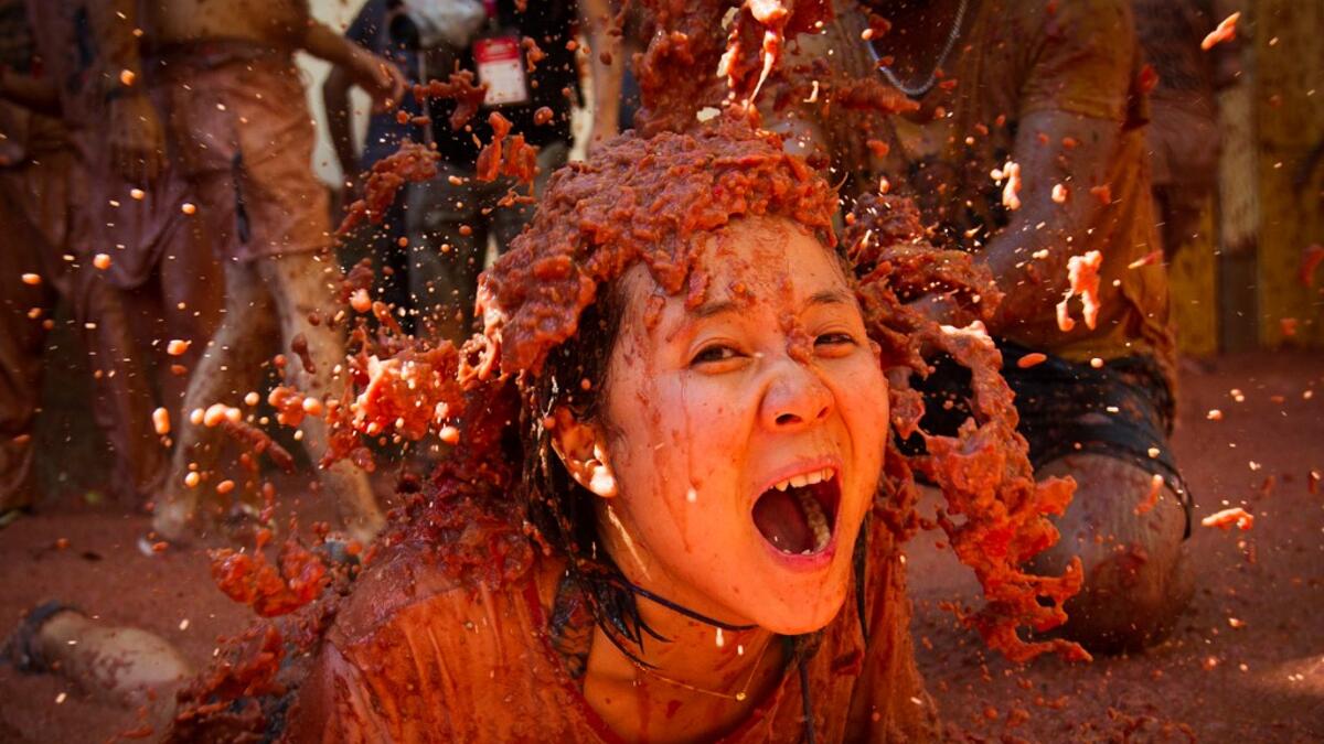 A reveller covered in tomato pulp participates in the annual "Tomatina" festival in the eastern town of Bunol, on August 28, 2019. JAIME REINA / AFP