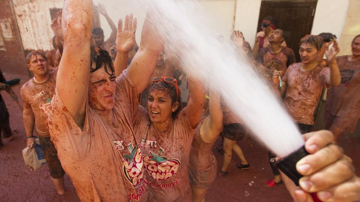 The iconic fiesta, which is billed at "the world's biggest food fight" has become a major draw for foreigners, in particular from Britain, Japan and the United States. JAIME REINA / AFP