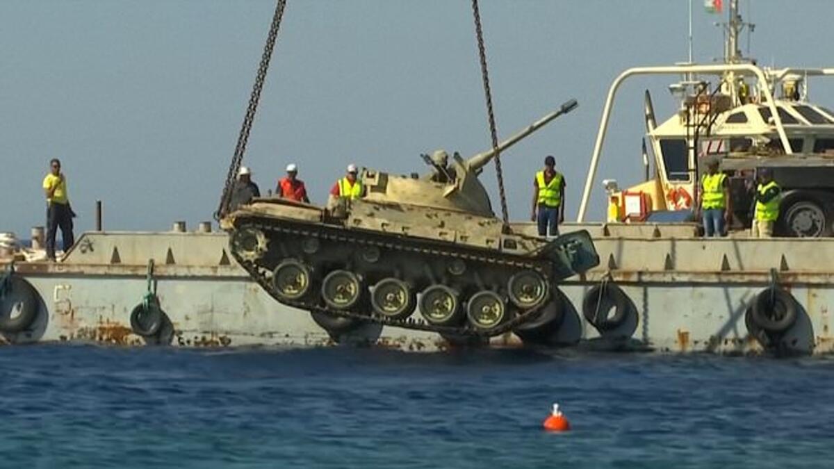 The crane lowers a Jordanian Armed Forces' armoured vehicle. (YouTube Screenshot)