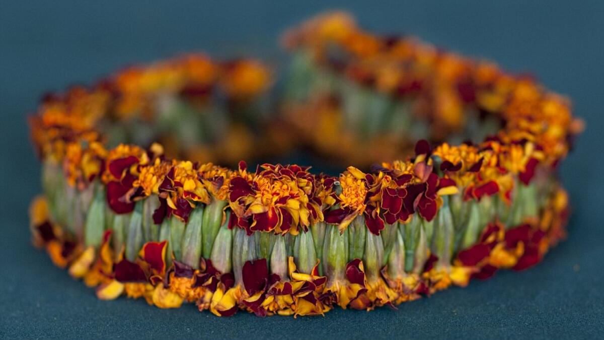 This garland is made from woven marigold heads, although most are made using fragrant wild jasmine and basil (Facebook)