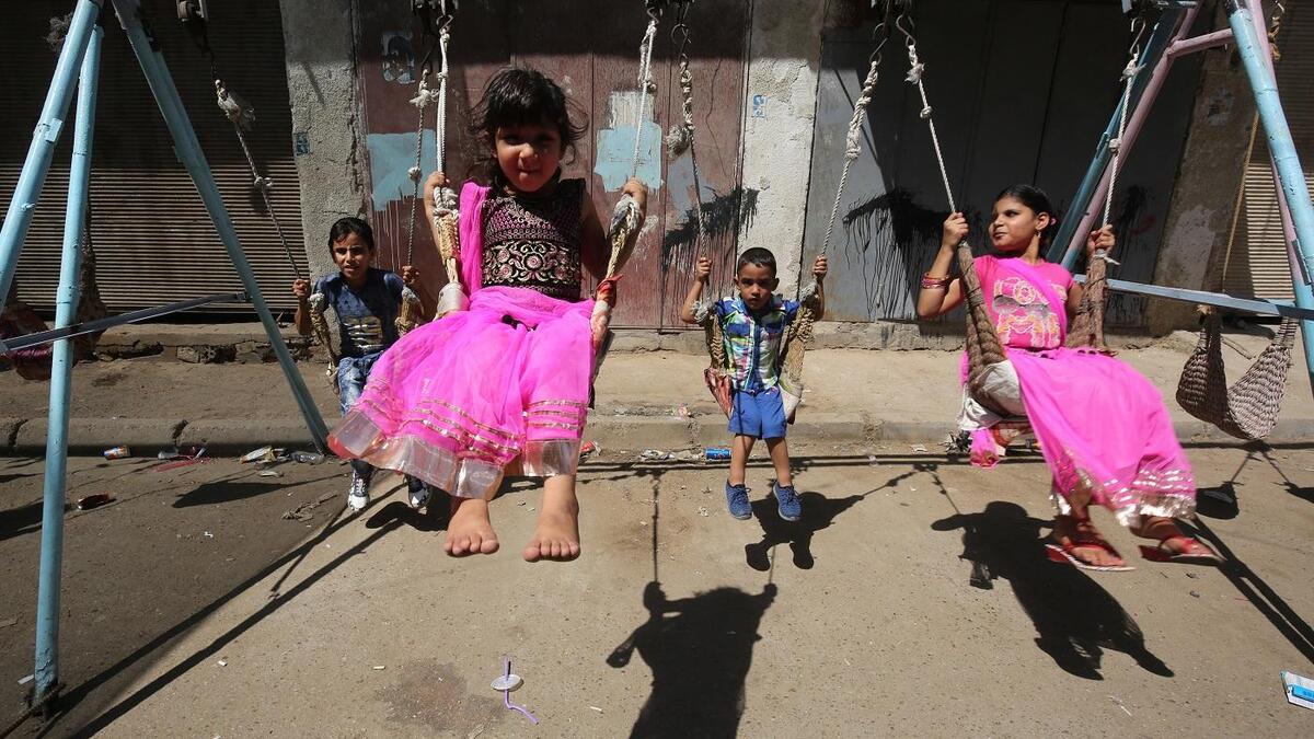 Iraqi children play on a street in Baghdad on the first day of Eid al-Adha. AFP/File Photo