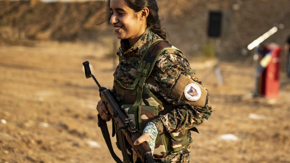 Members of the Bethnahrin Women Protection Forces (HSNB), an all-female Syriac-Assyrian paramilitary group under the umbrella of the Syrian Democratic Forces (SDF), march in line as they commemorate the fourth anniversary of their creation, in the countryside of the town of Tall Tamr in the northwestern Syrian province of Hasakah, on August 30, 2019.  Delil SOULEIMAN / AFP