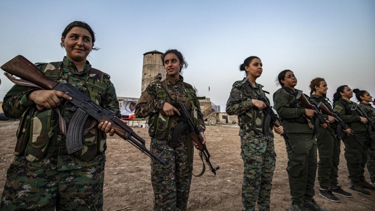 Members of the Bethnahrin Women Protection Forces (HSNB), an all-female Syriac-Assyrian paramilitary group under the umbrella of the Syrian Democratic Forces (SDF), line-up as they commemorate the fourth anniversary of their creation, in the countryside of the town of Tall Tamr in the northwestern Syrian province of Hasakah, on August 30, 2019.  Delil SOULEIMAN / AFP