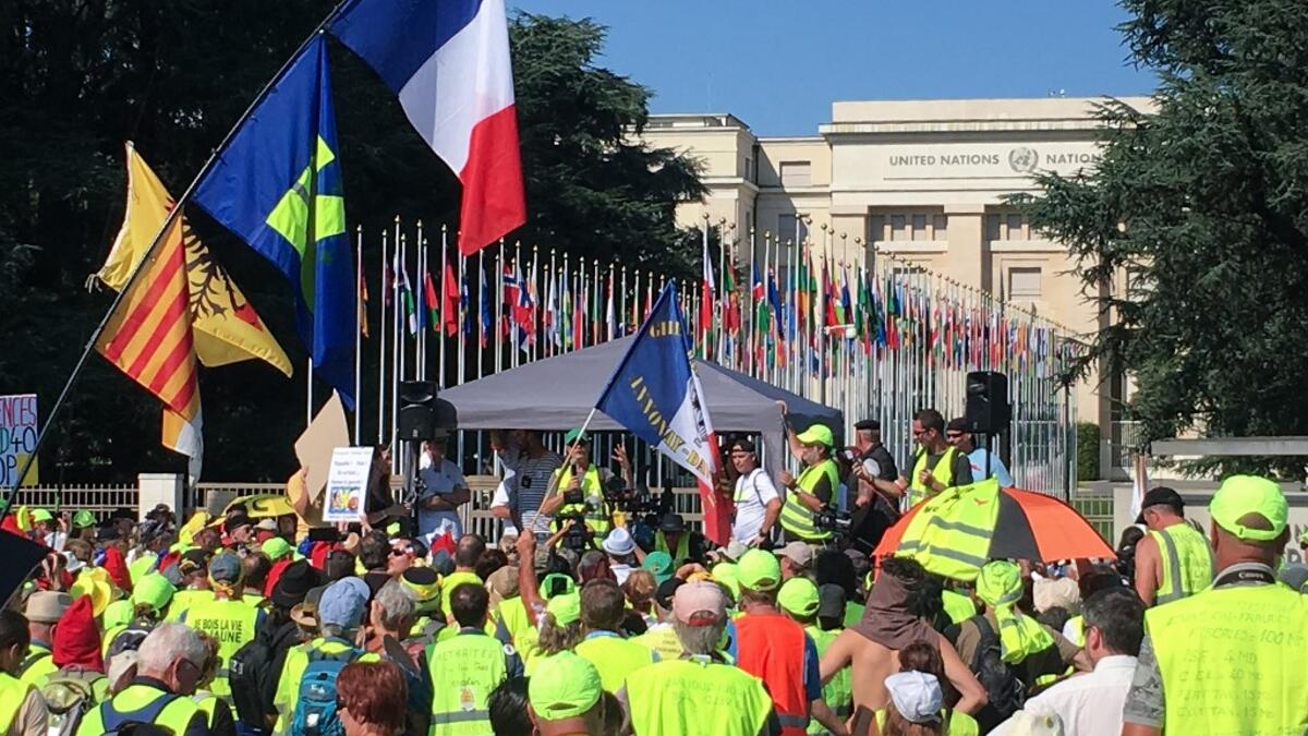 Members of the 'Yellow vests' mouvement protest in front of the United Nations office in Geneva against the police violence in France and the use of the LBD40 weapon manufactured in Switzerland, on August 31, 2019 in Geneva. ELOI ROUYER / AFP