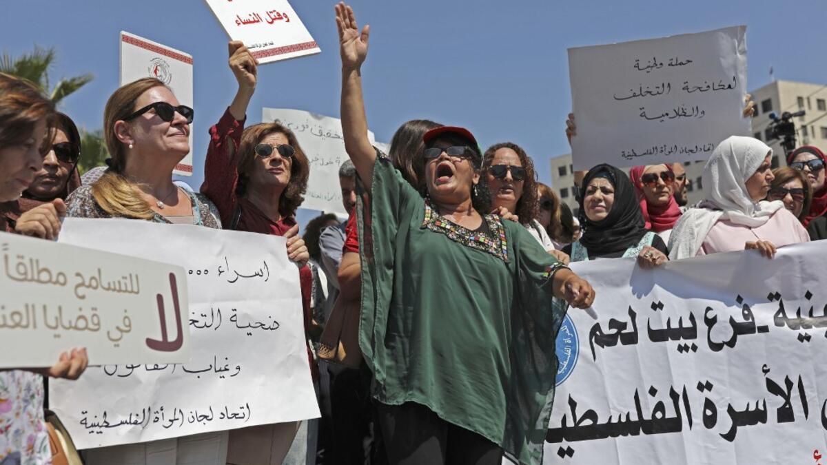 Palestinian women protest in support of women’s rights outside the prime minister’s office in the West Bank city of Ramallah on, after a young Palestinian died in a case that has raised emotions.  ABBAS MOMANI / AFP