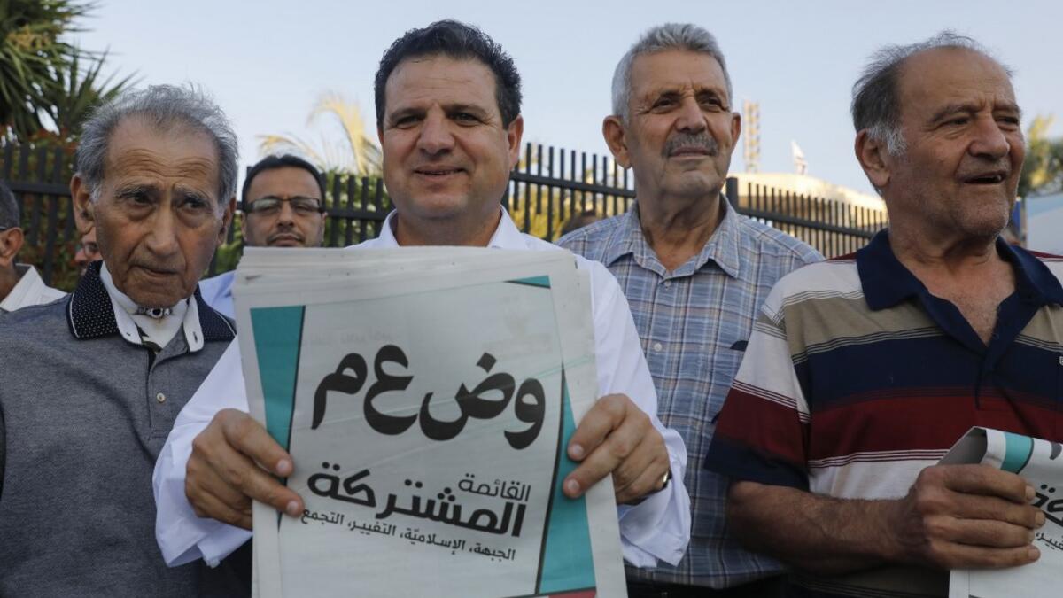 Ayman Odeh, head of the Arab Joint List alliance, holds his pamphlets during a campaign rally in the Arab Israeli city of Tira, north of Tel Aviv, on September 5, 2019 . AHMAD GHARABLI / AFP