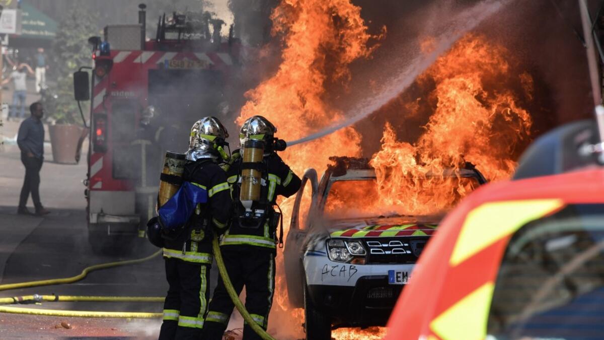 French firefighters spray water to extinguish a burning French Municipal Police car on the sidelines of an anti-government demonstration called by the "Yellow Vests" (Gilets Jaunes) movement in Montpellier, southern France on September 7, 2019. Pascal GUYOT / AFP