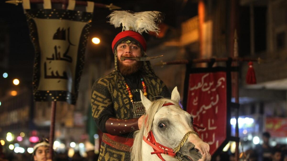 Iraqi Shiites in costumes re-enact events of Ashura in the capital Baghdad's mostly Shiite neighbourhood of Kadhimiya, marking the 8th day of Muharram.  Ahmad AL-RUBAYE / AFP
