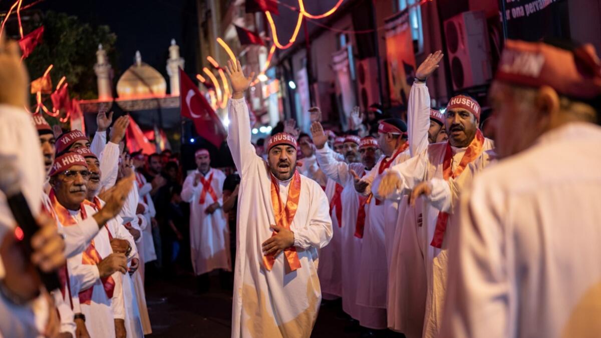 Turkish Shiite men walk during the Shi'ite Tasoua religious event, a day ahead of Ashura on September 8, 2019, in Istanbul. Ashura commemorates the killing of Imam Hussein, a grandson of the Prophet Mohammed, by armies of the caliph Yazid in 680 AD. Tradition holds that the revered imam was decapitated and his body mutilated in the Battle of Karbala. Yasin AKGUL / AFP
