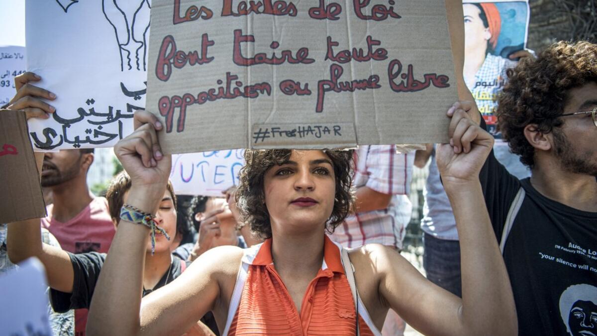 A demonstrator holds up a sign reading in French "the texts of the law silence all opposition or freedom of speech", during a protest outside a courthouse holding the trial of Hajar Raissouni, a Moroccan journalist of the daily newspaper Akhbar El-Youm, on charges of abortion, in the capital Rabat on September 9, 2019. FADEL SENNA / AFP