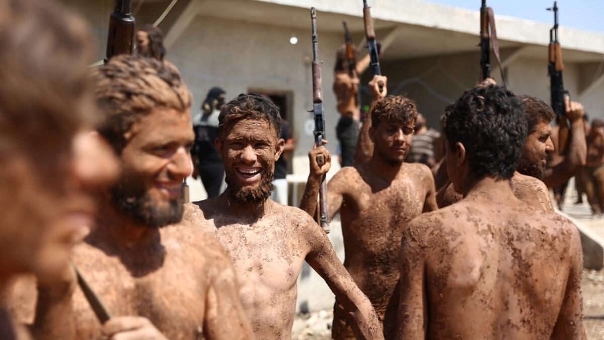 Syrian Turkish-backed fighters from al-Mutasim Brigade react after finishing their training at a camp near the town of Marea in Syria's northern Aleppo district, on September 12, 2019. Nazeer Al-khatib / AFP