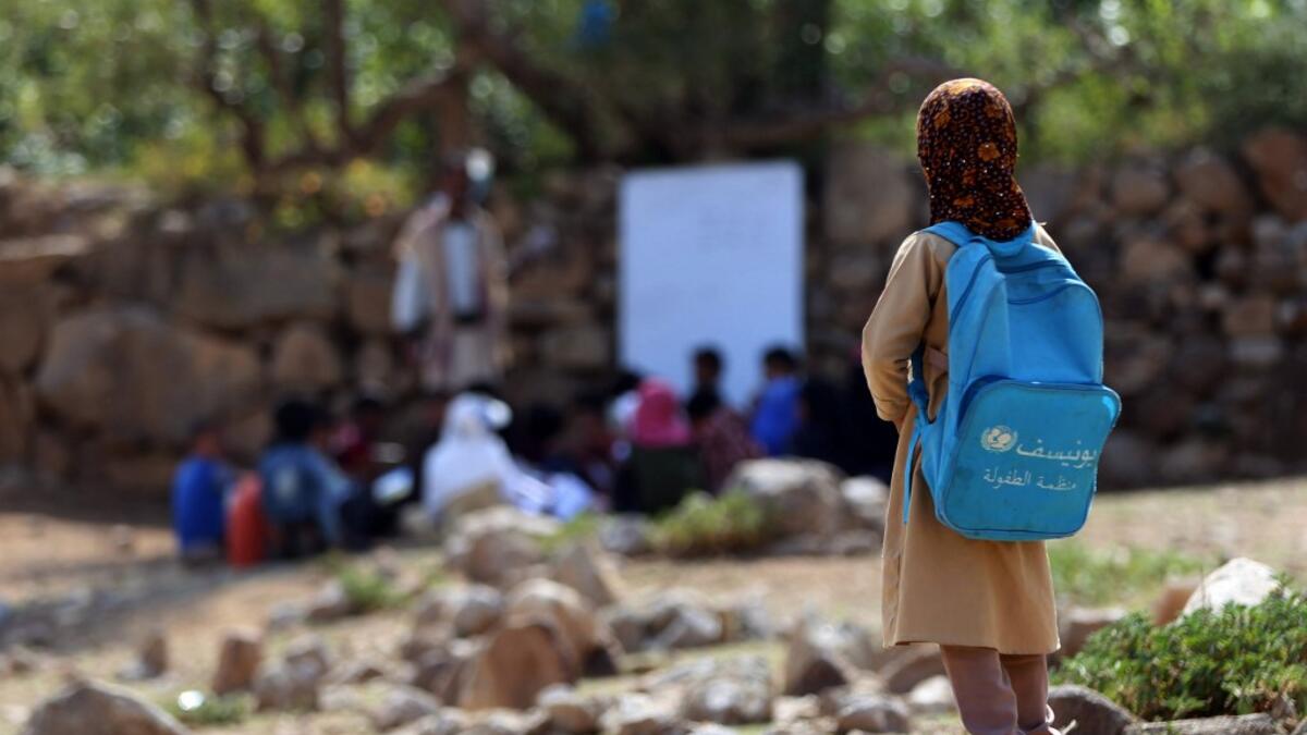 Yemeni school children attend an open-air class under a tree near their unfinished school  Ahmad AL-BASHA / AFP