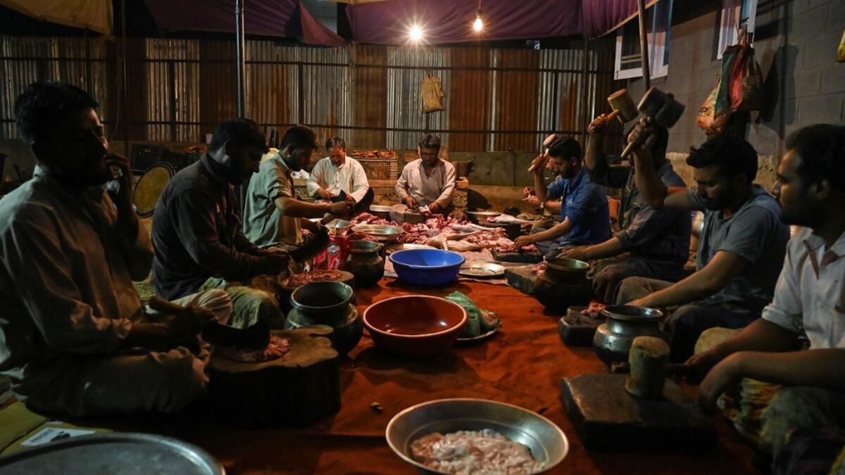 In this photo taken on September 15, 2019, chefs prepare mutton for a variety of traditional dishes for a marriage ceremony in Kashmir's Baramulla district, north of Srinagar. TAUSEEF MUSTAFA / AFP