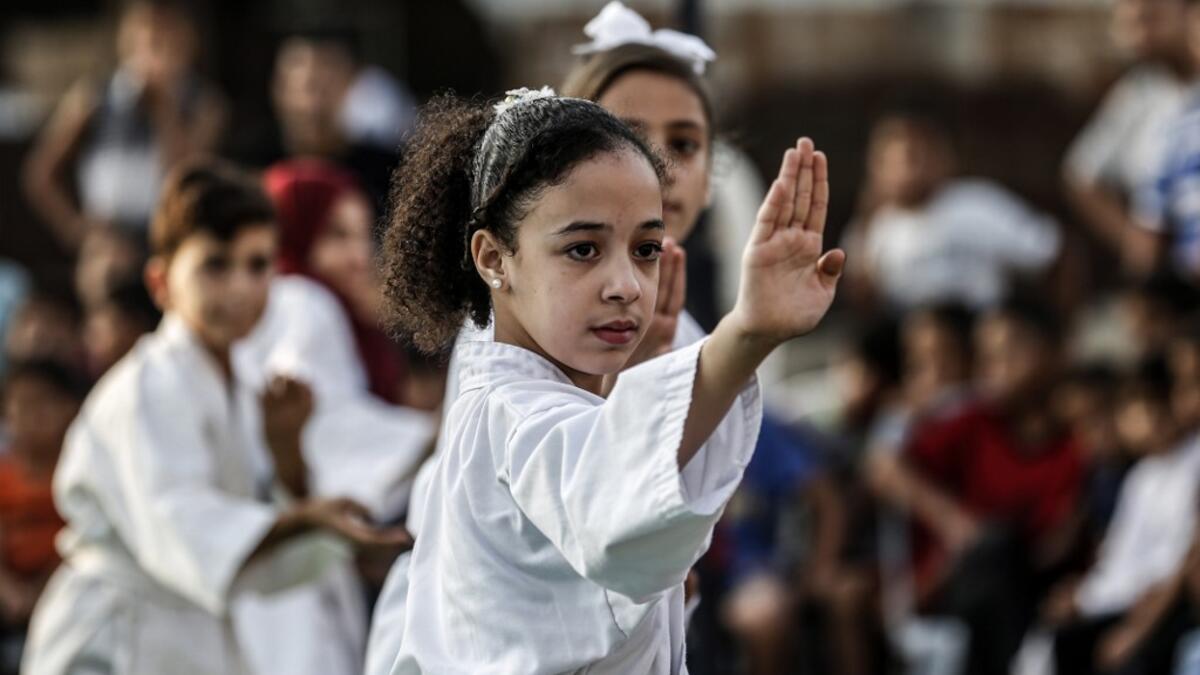 Young Palestinian karatekas demonstrate their skills during a Karate promotion ceremony at a sporting centre in the Rafah camp for Palestinian refugees in the southern Gaza Strip on September 20, 2019. SAID KHATIB / AFP