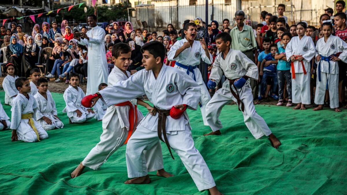 Young Palestinian karatekas demonstrate their skills during a Karate promotion ceremony at a sporting centre in the Rafah camp for Palestinian refugees in the southern Gaza Strip on September 20, 2019. SAID KHATIB / AFP