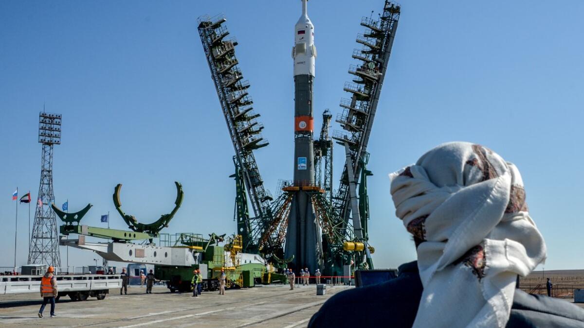 A United Arab Emirates' journalist looks on as the Soyuz booster rocket FG with Soyuz MS-15 spacecraft is mounted on the launch pad at the Russian-leased Baikonur cosmodrome in Kazakhstan on September 23, 2019. Vyacheslav OSELEDKO / AFP