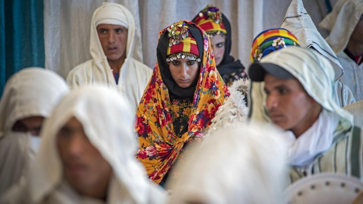 Young Amazigh (Berber) men and women wait for their wedding ceremony during the annual "Engagement Moussem" festival near the village of Imilchil in central Morocco's high Atlas Mountains on September 21, 2019. Each year in the High Atlas Mountains hamlet of Ait Amer, tribes celebrate with dances and music, the collective wedding of young Amazigh couples during the traditional festival of "Engagement Moussem". FADEL SENNA / AFP