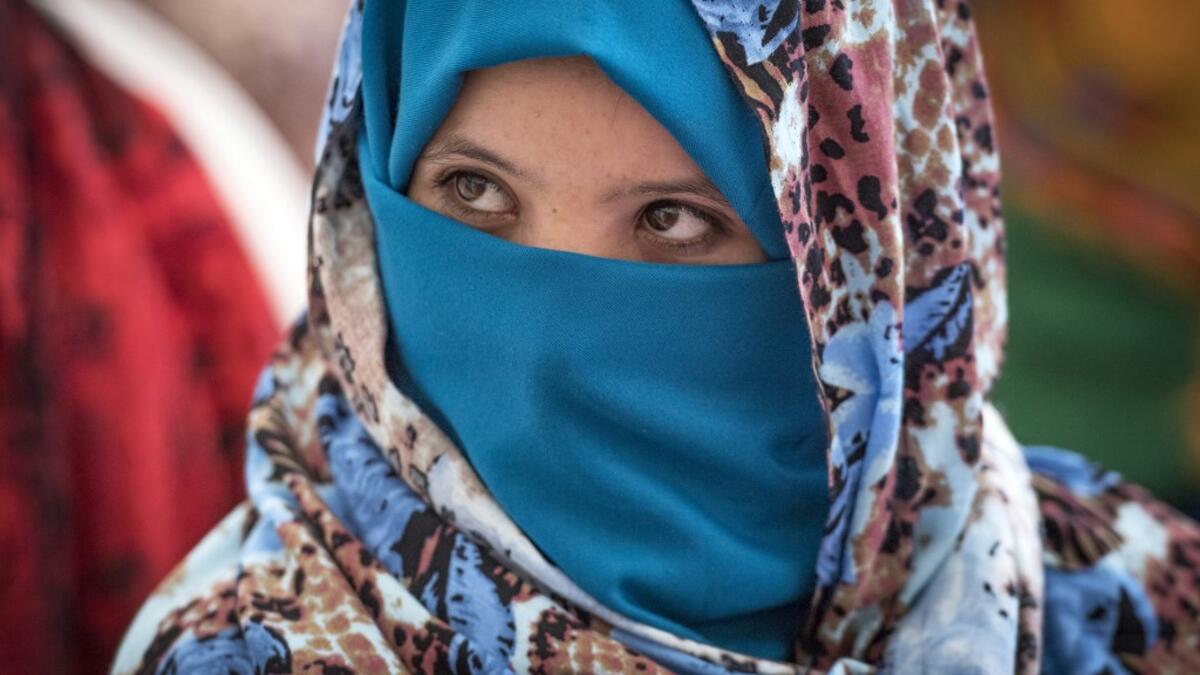 A Young Amazigh (Berber) woman waits for her wedding ceremony during the annual "Engagement Moussem" festival near the village of Imilchil in central Morocco's high Atlas Mountains on September 21, 2019. Each year in the High Atlas Mountains hamlet of Ait Amer, tribes celebrate with dances and music, the collective wedding of young Amazigh couples during the traditional festival of "Engagement Moussem". FADEL SENNA / AFP