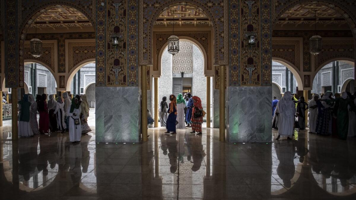 Worshippers enter the Great Mosque of the Mourides on September 27, 2019 in Dakar, ahead of its inauguration. Senegal's influential Mouride Brotherhood will inaugurate a 30,000-capacity mosque in the capital Dakar, said to be the largest in West Africa. JOHN WESSELS / AFP