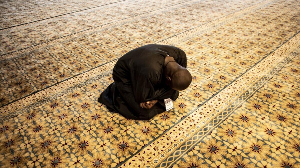 A worshipper reacts after entering the Great Mosque of the Mourides on September 27, 2019 in Dakar, ahead of its inauguration. Senegal's influential Mouride Brotherhood will inaugurate a 30,000-capacity mosque in the capital Dakar, said to be the largest in West Africa. JOHN WESSELS / AFP