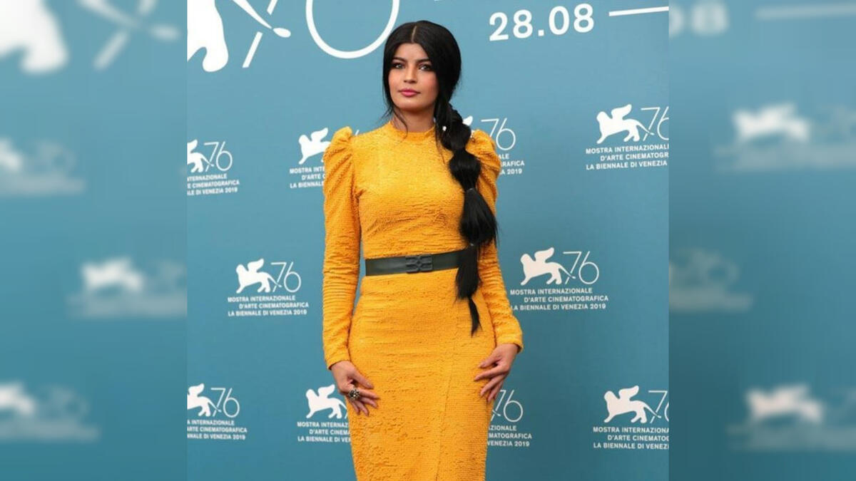 For her second appearance, she wore a mustard yellow dress designed by Eman Alajlan