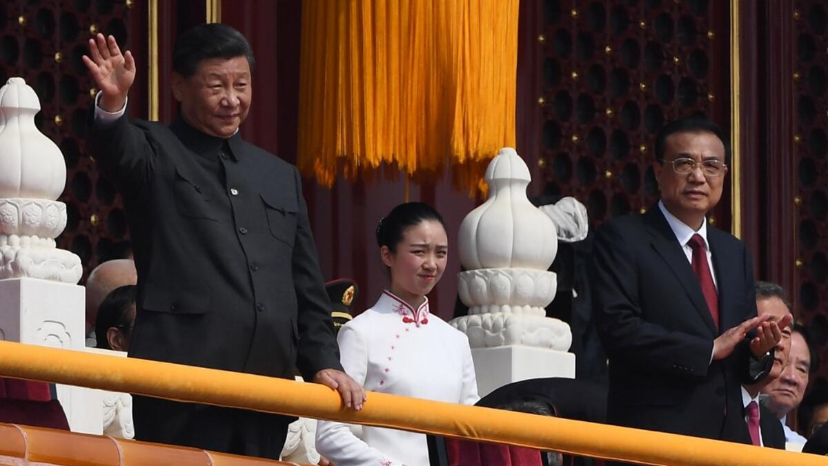Chinese President Xi Jinping (C) attends a military parade with former presidents Hu Jintao (L) and Jiang Zemin in Tiananmen Square in Beijing on October 1, 2019, to mark the 70th anniversary of the founding of the PeopleÕs Republic of China. GREG BAKER / AFP