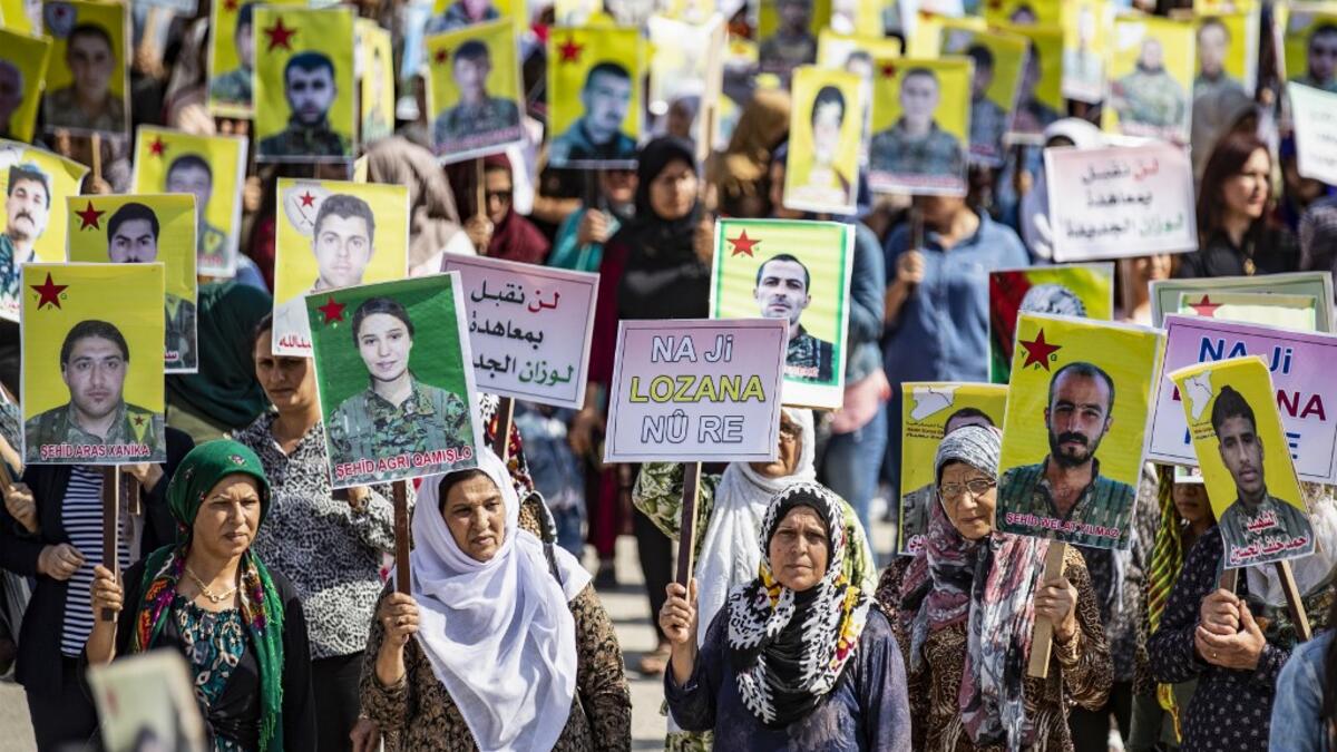 Syrian Kurds demonstrate in front of the United Nations offices in the Kurdish-majority city of Qamishli in northeast Syria on October 2, 2019 over their exclusion from the UN-backed constitutional committee. Delil SOULEIMAN / AFP