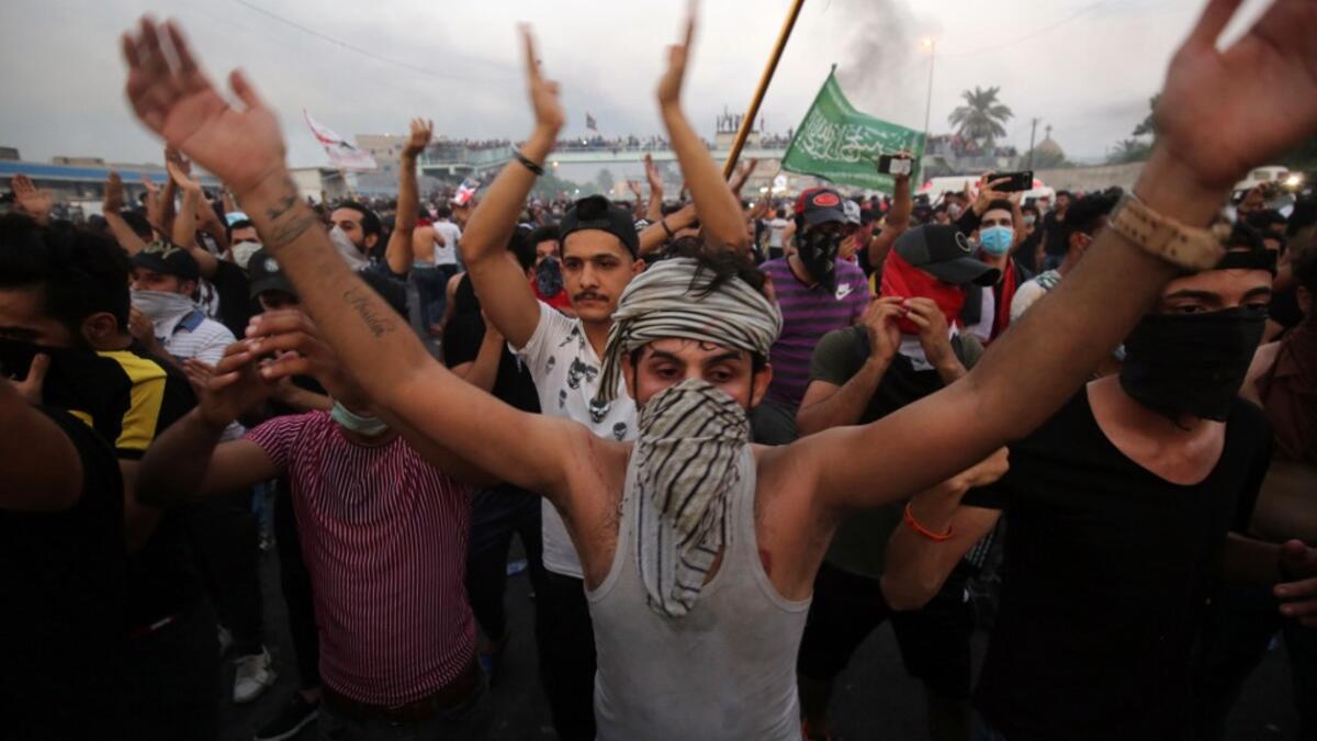 Iraqi protesters chant slogans during a demonstration against state corruption, failing public services and unemployment at Tayaran square in Baghdad on October 2, 2019. Iraq's president and the United Nations urged security forces to show restraint after two protesters were killed in clashes with police that other top officials blamed on "infiltrators." AHMAD AL-RUBAYE / AFP