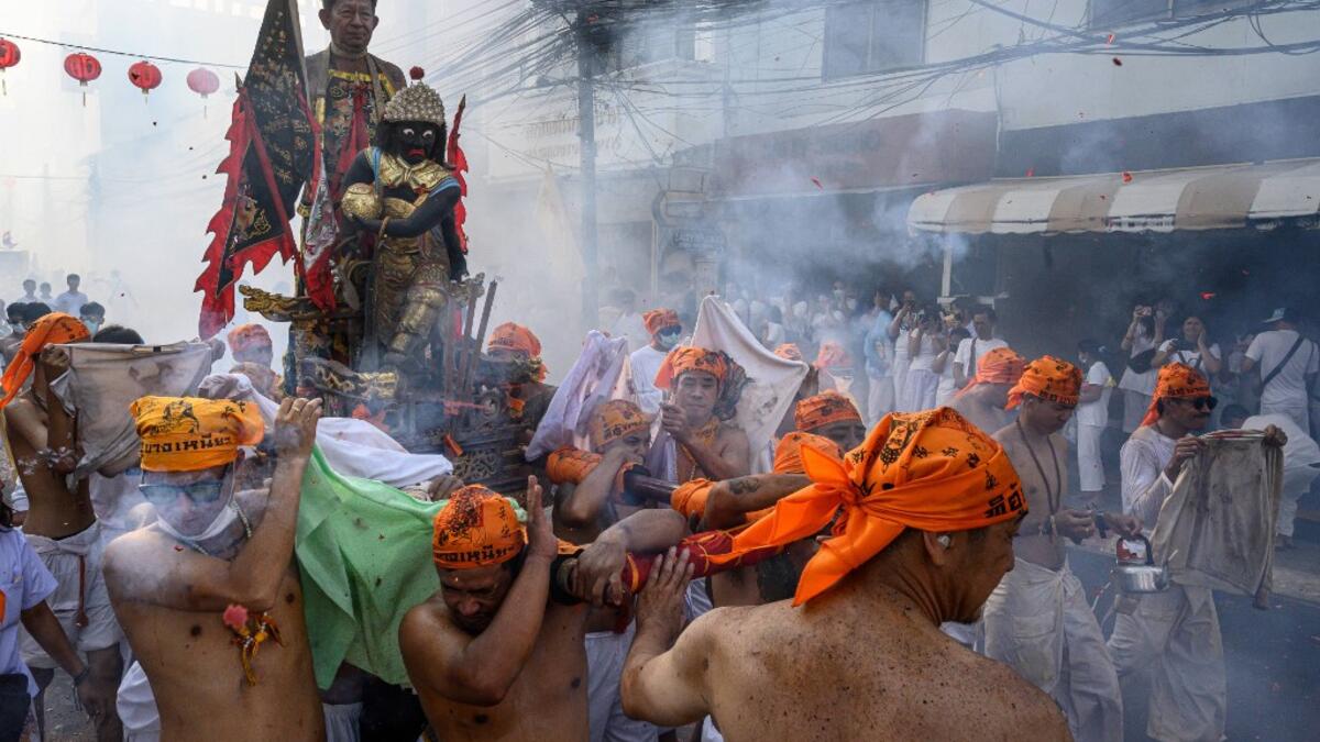 The festival begins on the first evening of the ninth lunar month and lasts for nine days, with many religious devotees slashing themselves with swords, piercing their cheeks with sharp objects and committing other painful acts to purify themselves, taking on the sins of the community. Mladen ANTONOV / AFP
