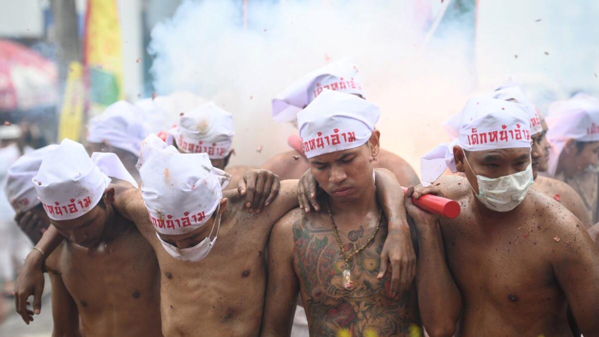 The festival begins on the first evening of the ninth lunar month and lasts for nine days, with many religious devotees slashing themselves with swords, piercing their cheeks with sharp objects and committing other painful acts to purify themselves, taking on the sins of the community. Mladen ANTONOV / AFP