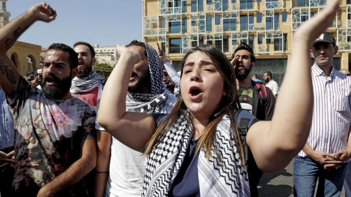 Lebanese protesters chants slogans during a demonstration in central Beirut's Martyr Square on October 6, 2019. Lebanese protested in the capital over increasingly difficult living conditions, amid fears of a dollar shortage and possible price hikes. ANWAR AMRO / AFP