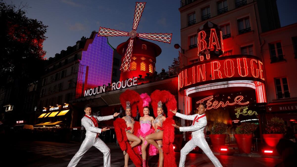 Moulin Rouge cabaret's French dancer Mathilde (2ndL) and Australian dancer Rhylee (2ndR) pose during the celebration of the 130th anniversary of the French oldest cabaret, on October 6, 2019 in Paris.  GEOFFROY VAN DER HASSELT / AFP