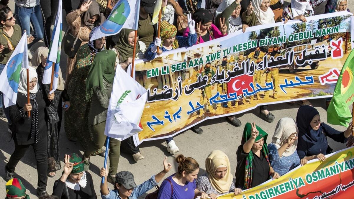Syrian Kurds take part in a demonstration against Turkish threats in Ras al-Ain town in Syria's Hasakeh province near the Turkish border on October 9, 2019. Syrian Kurds called on Damascus ally Moscow to facilitate "dialogue" with the regime, following threats of a Turkish invasion of northeastern Syria. Delil SOULEIMAN / AFP