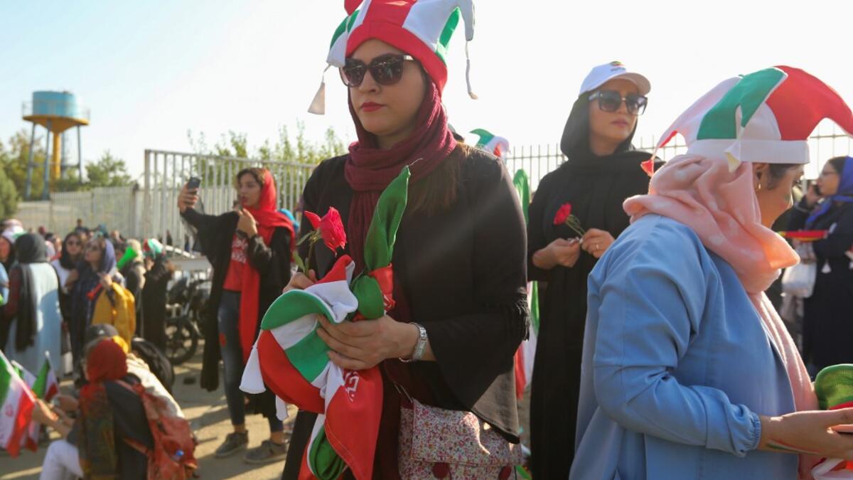 Iranian women attend the World Cup Qatar 2022 Group C qualification football match between Iran and Cambodia at the Azadi stadium in the capital Tehran on October 10, 2019. ATTA KENARE / AFP