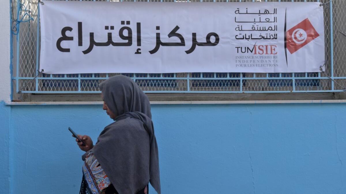 A Tunisian voter waits outside a polling station in the capital Tunis on October 13, 2019 during the second round of the presidential election. Tunisians began voting today in a presidential runoff pitting conservative law professor Kais Saied against media magnate Nabil Karoui, who was released from prison just days earlier. Fethi Belaid / AFP