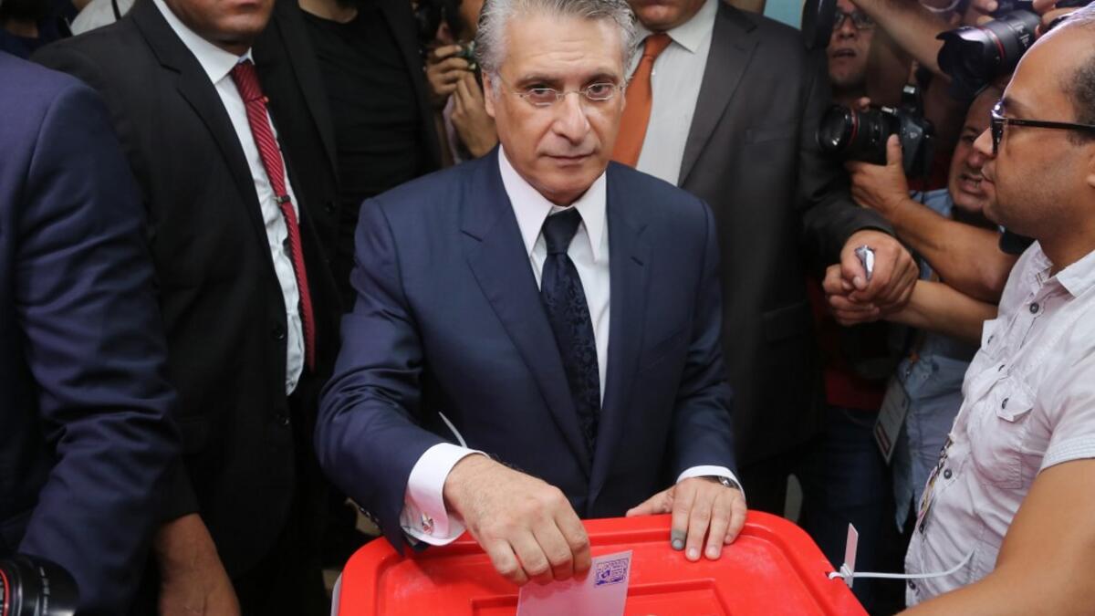 Tunisia's presidential candidate Nabil Karoui casts his ballot at a polling station in the capital Tunis on October 13, 2019 during the second round of the presidential election. Tunisians began voting today in a presidential runoff pitting conservative law professor Kais Saied against media magnate Nabil Karoui, who was released from prison just days earlier. ANIS MILI / AFP