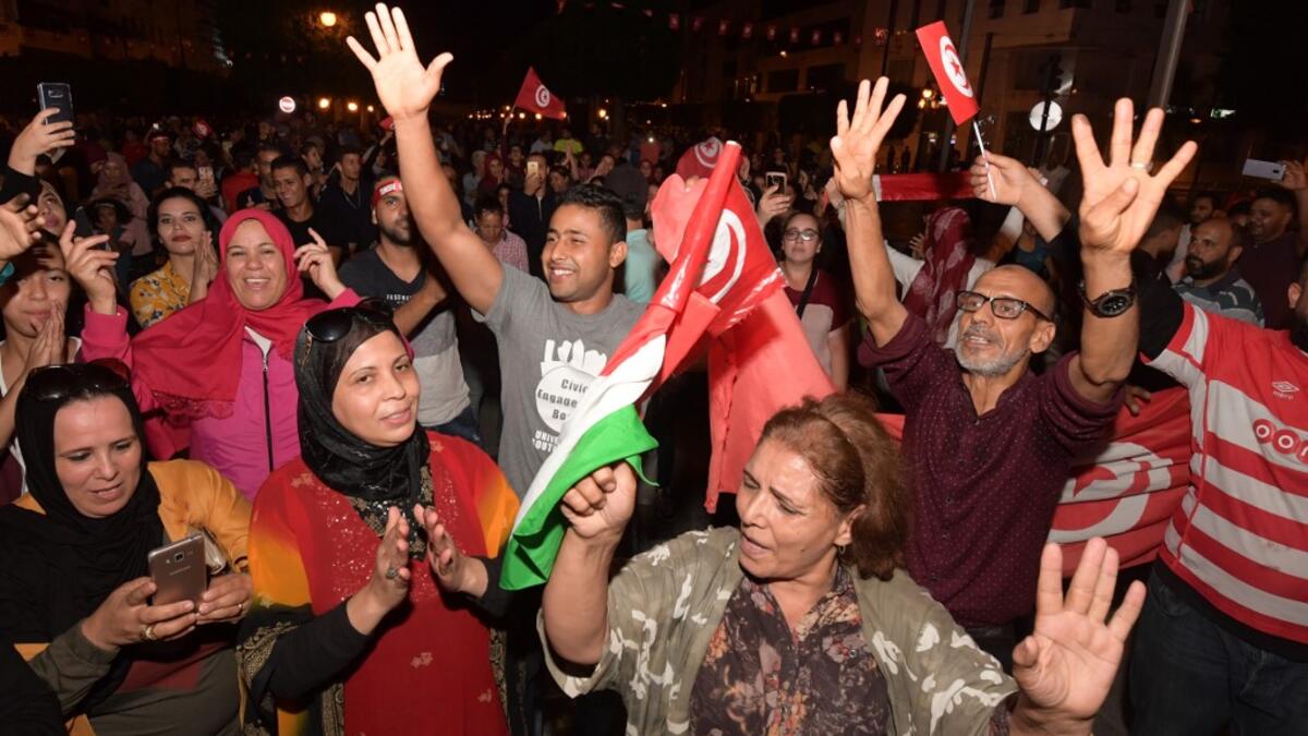 Tunisians gather to celebrate the victory of Kais Saied in the Tunisia's presidential runoff on October 13, 2019, in the capital Tunis. Conservative academic Kais Saied, a political outsider, won a landslide victory Sunday in Tunisia's presidential runoff, sweeping aside his rival, media magnate Nabil Karoui, state television said. Fethi Belaid / AFP