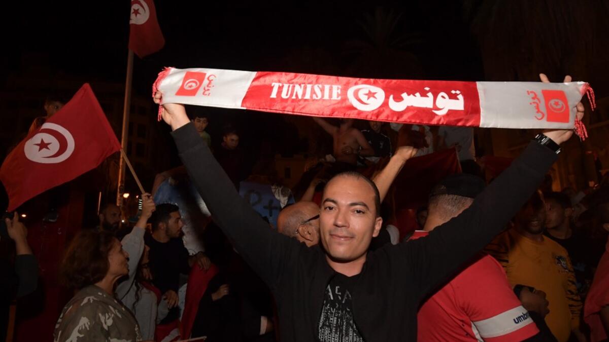 Tunisians gather to celebrate the victory of Kais Saied in the Tunisia's presidential runoff on October 13, 2019, in the capital Tunis. Conservative academic Kais Saied, a political outsider, won a landslide victory Sunday in Tunisia's presidential runoff, sweeping aside his rival, media magnate Nabil Karoui, state television said. Fethi Belaid / AFP