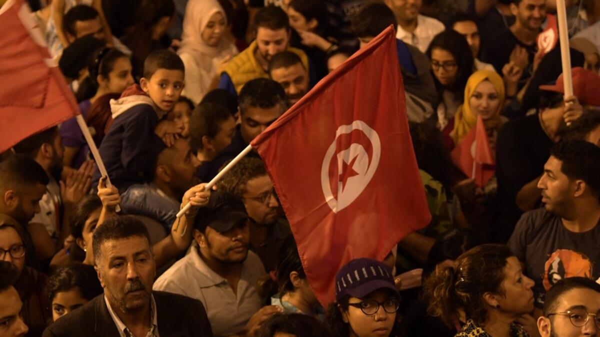 Tunisians gather to celebrate the victory of Kais Saied in the Tunisia's presidential runoff on October 13, 2019, in the capital Tunis. Conservative academic Kais Saied, a political outsider, won a landslide victory Sunday in Tunisia's presidential runoff, sweeping aside his rival, media magnate Nabil Karoui, state television said. Fethi Belaid / AFP