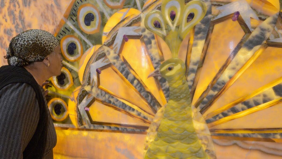 A woman kisses an image of the Melek Taus, or the Peacock Angel, in the new Yazidi Temple in the village of Aknalich, 35 kilometres from the Armenian capital Yerevan,  KAREN MINASYAN / AFP