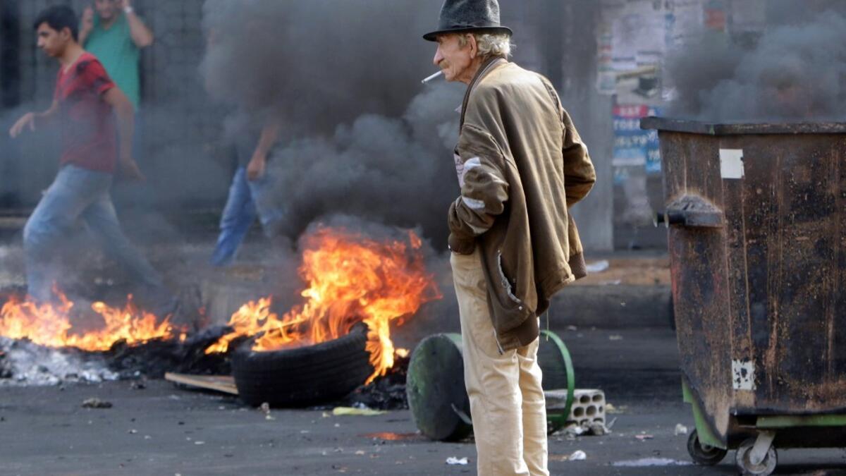 Lebanese demonstrators burn tires during a protest against dire economic conditions, on October 18, 2019 in the northern port city of Tripoli The Lebanese government faced calls to resign Thursday after thousands of furious demonstrators took to the streets across the country to protest dire economic conditions. Ibrahim CHALHOUB / AFP