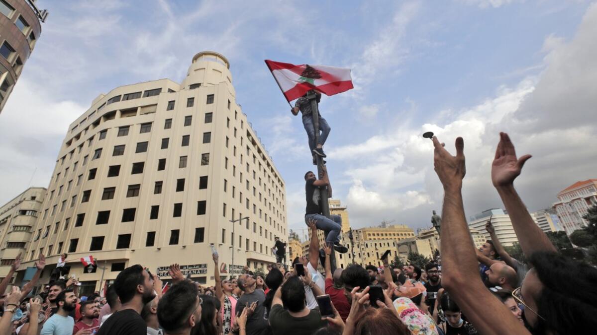 Lebanese demonstrators gather during a mass protest in the centre of the capital Beirut on October 18, 2019 against dire economic conditions. Public anger has simmered since parliament passed an austerity budget in July to help trim a ballooning deficit and flared on October 17 over new plans to tax calls on messaging applications such as WhatsApp, forcing the government to axe the unpopular proposal. ANWAR AMRO / AFP