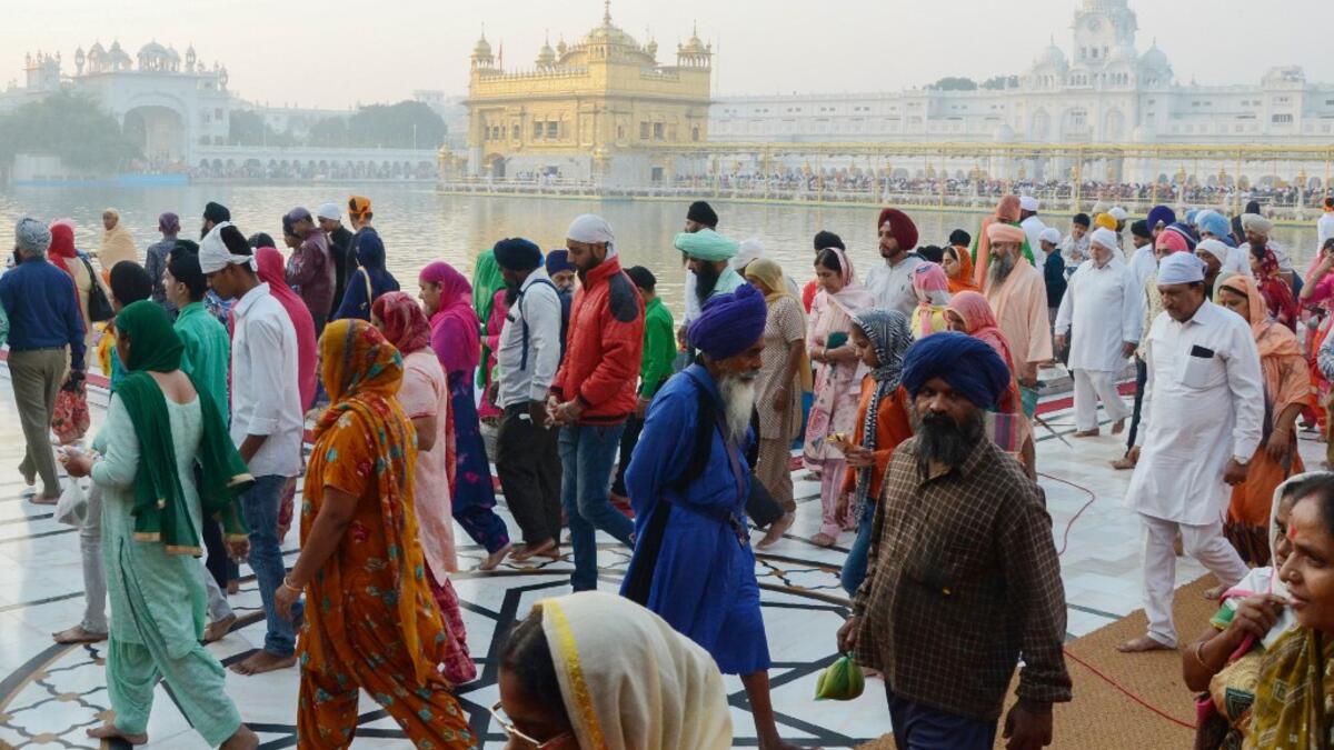 Sikh devotees visit the Golden Temple to mark Bandi Chhor Divas which coincides with the day of Diwali in Amritsar on October 27, 2019. Sikhs celebrate Bandi Chhor Divas on the same day as the Hindu festival of Diwali, to mark the historic return of the sixth Guru Hargobind. NARINDER NANU / AFP