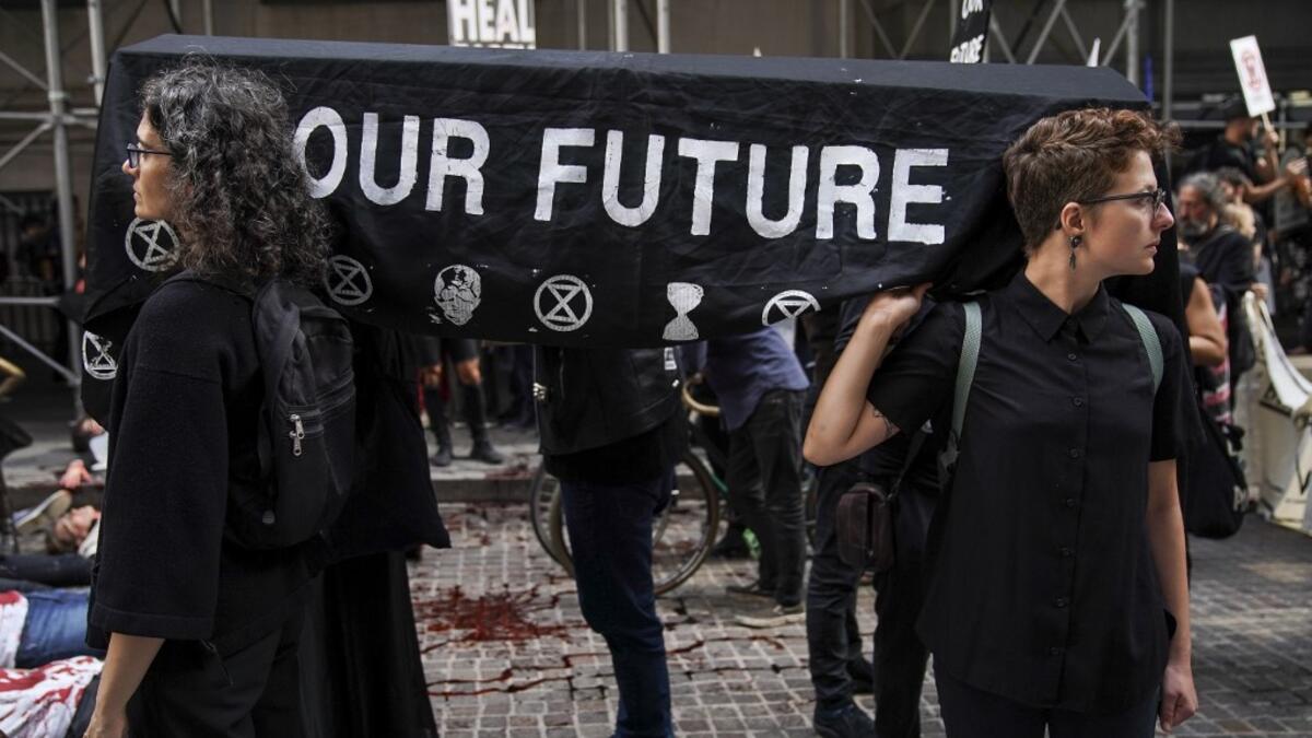 Environmental activists participate in a die-in during a rally for action against climate change in the Financial District October 7, 2019 in New York City. The group 'Extinction Rebellion' has organized protests and sit-ins around the globe today to push for action against climate change. Drew Angerer/Getty Images/AFP D