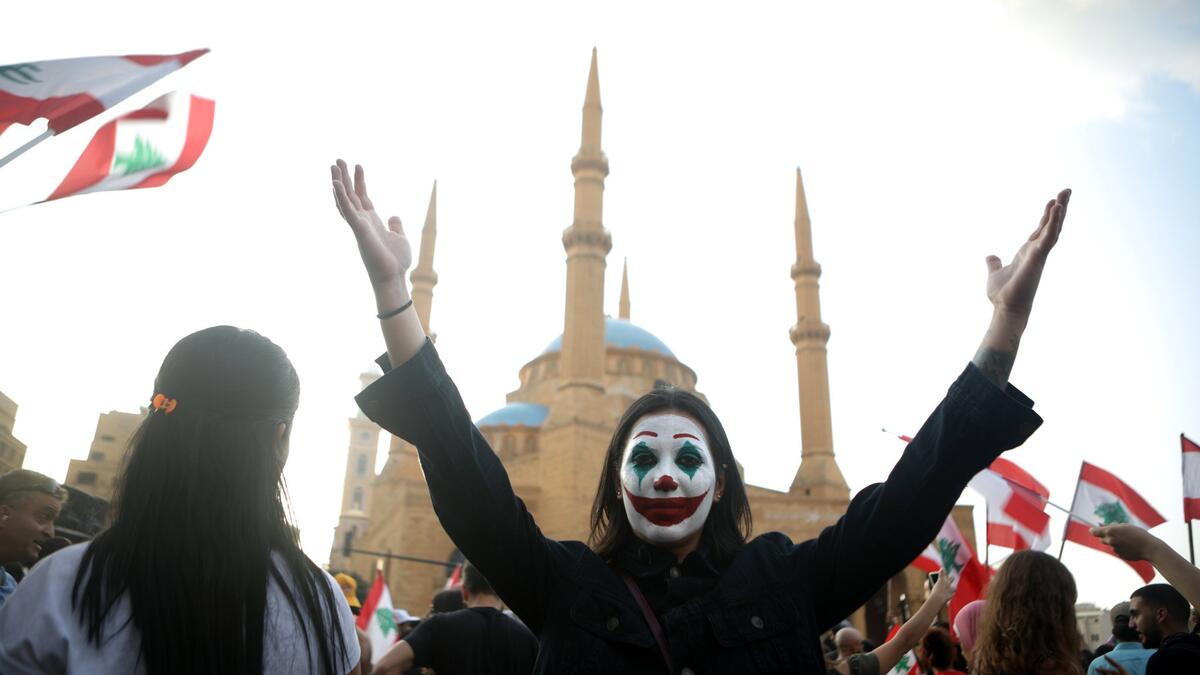 A Lebanese demonstrator, her face painted as DC comic book and film character "The Joker", takes part in a protest in the capital Beirut's downtown district's Martyr's Square (Twitter)
