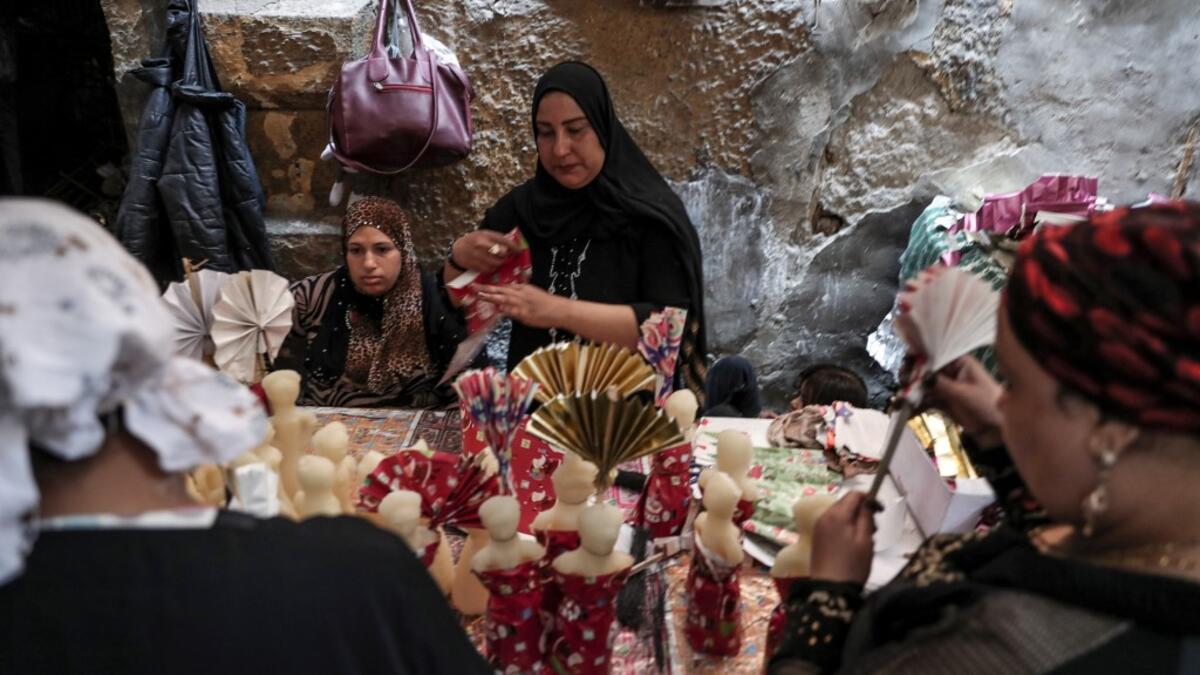 Egyptian women decorate traditional sugar statuettes in the capital Cairo on November 2, 2019, ahead of celebrations of the Muslim Prophet Mohammed's birthday, known as "Al Mawlid Al Nabawi". Prophet Mohamed was born in Saudi Arabia's arid mountainous city of Mecca, the holiest in Islam, some 1490 years ago. Sunni Muslims in many parts of the world celebrate his birthday on the 12th day of the third month of the Islamic calendar, which will fall this year on November 9th.  Mohamed el-Shahed / AFP
