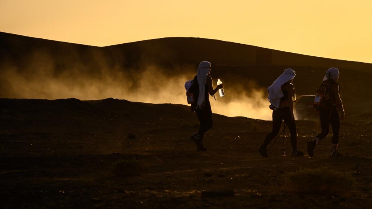 Women take part in the desert trek "Rose Trip Maroc", on November 3, 2019 in the erg Chebbi near Merzouga. The Rose Trip Maroc is a female-oriented trek where teams of three must travel through the southern Moroccan Sahara desert with a compass, a map and a topographical reporter. JEAN-PHILIPPE KSIAZEK / AFP